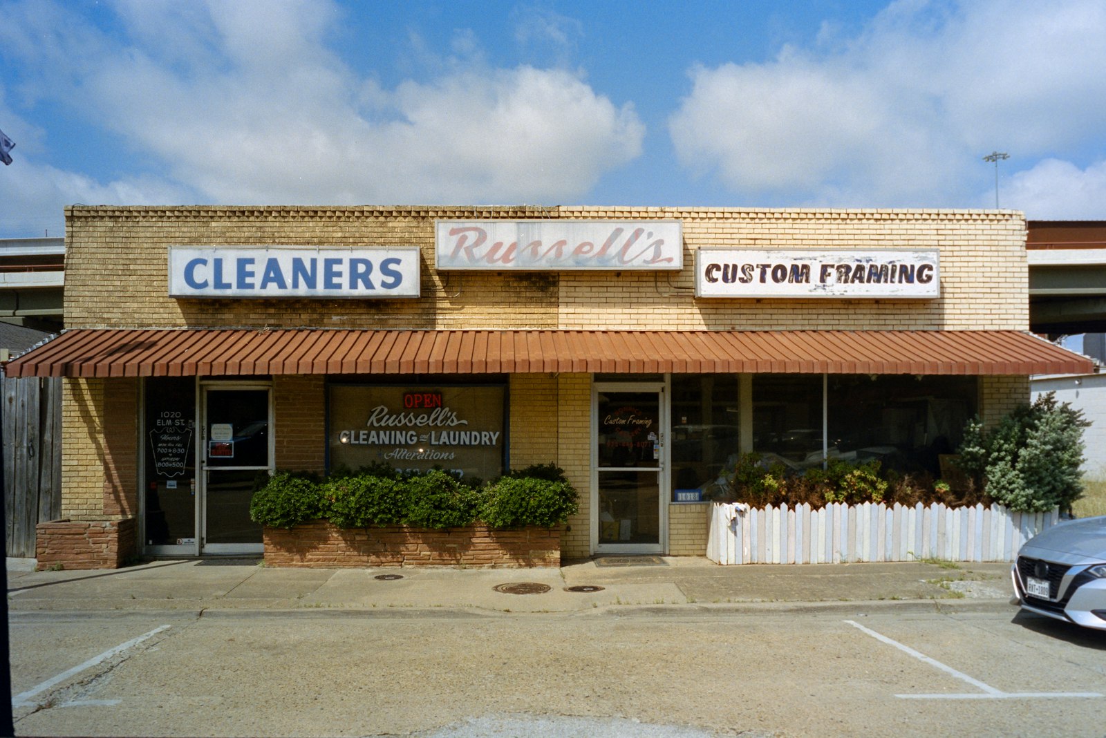 Small-business commercial storefront strip with awnings and signage — example of property type Broad Street Pressure Wash services in Charleston SC
