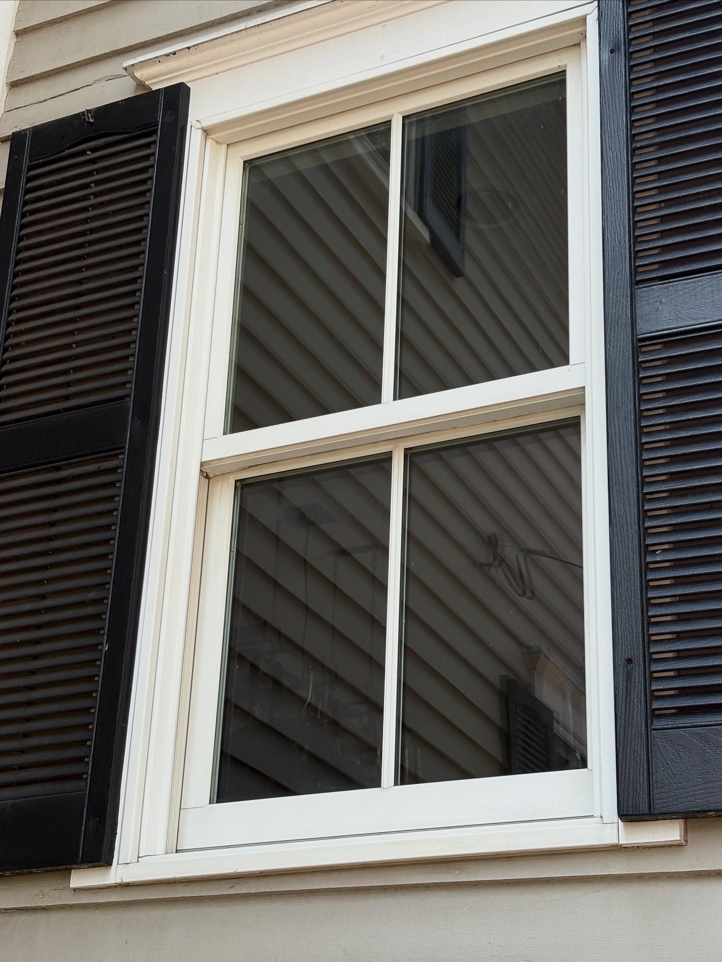 Window and siding cleaned with pressure washing.